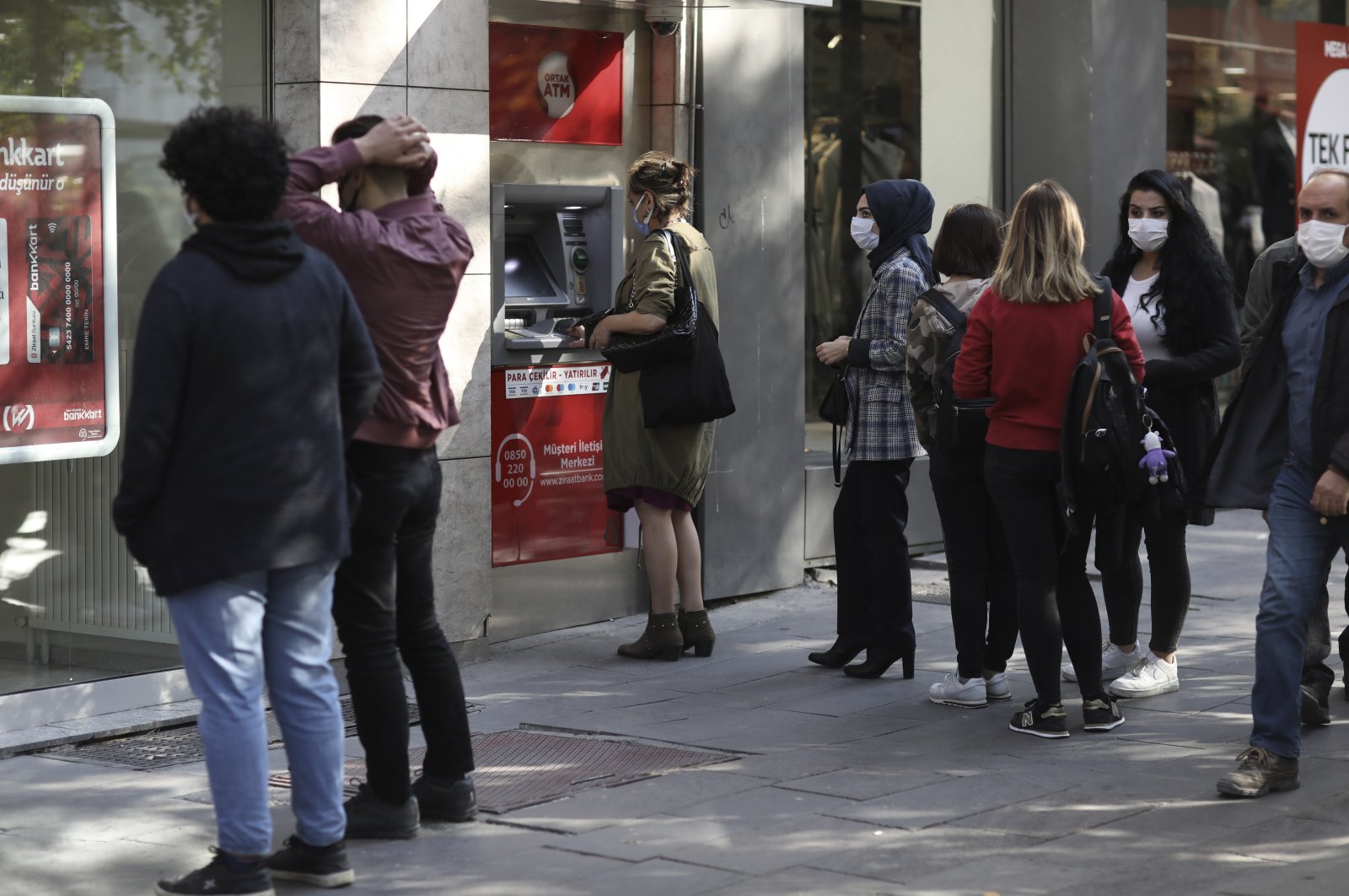 People line up to retrieve money from a bank ATM in the capital, Ankara, Türkiye, Oct. 22, 2021. (AP Photo)