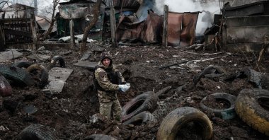 A police officer inspects a hole after a rocket strike, in Kramatorsk, Ukraine, February 2, 2023, amid the Russian invasion of Ukraine. (AFP Photo)