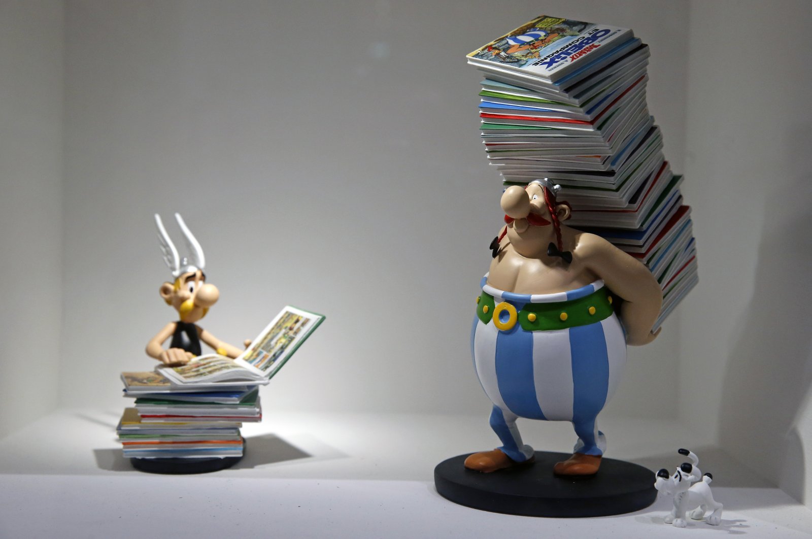 Figurines of characters of Asterix and Obelix created by French designer Uderzo are on display at the &quot;Uderzo, Comme Une Potion Magique&quot; (Uderzo, Like A Magic Potion) exhibition at the Maillol Museum, Paris, France, May 25, 2021. (Getty Images Photo)