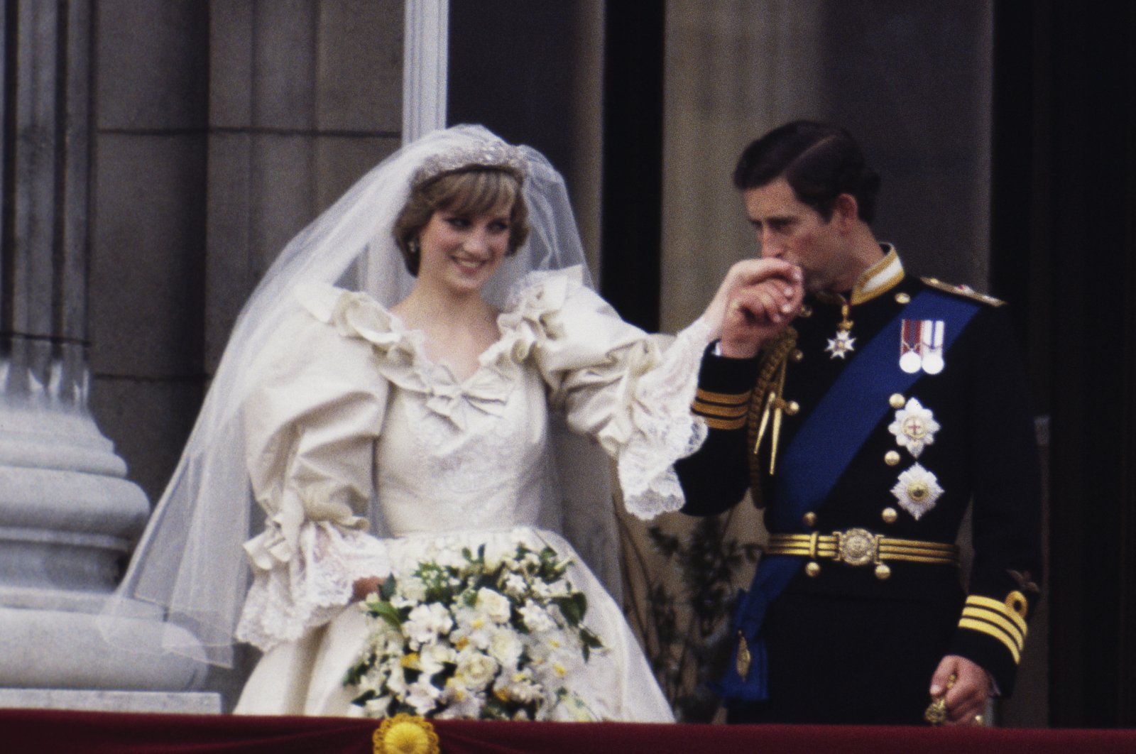 The Prince and Princess of Wales on the balcony of Buckingham Palace on their wedding day, as Diana wears a wedding dress by David and Elizabeth Emmanuel and the Spencer family tiara, London, U.K., July 29, 1981. (Getty Images Photo)