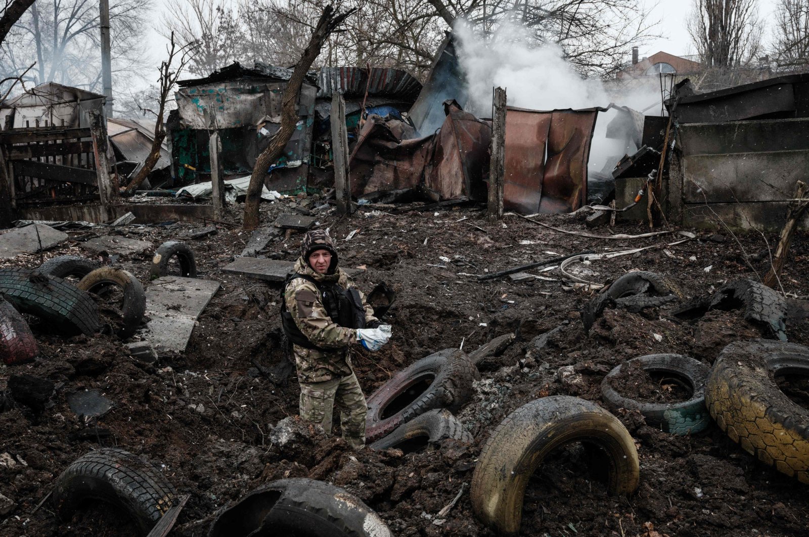 A police officer inspects a hole after a rocket strike, in Kramatorsk, Ukraine, February 2, 2023, amid the Russian invasion of Ukraine. (AFP Photo)