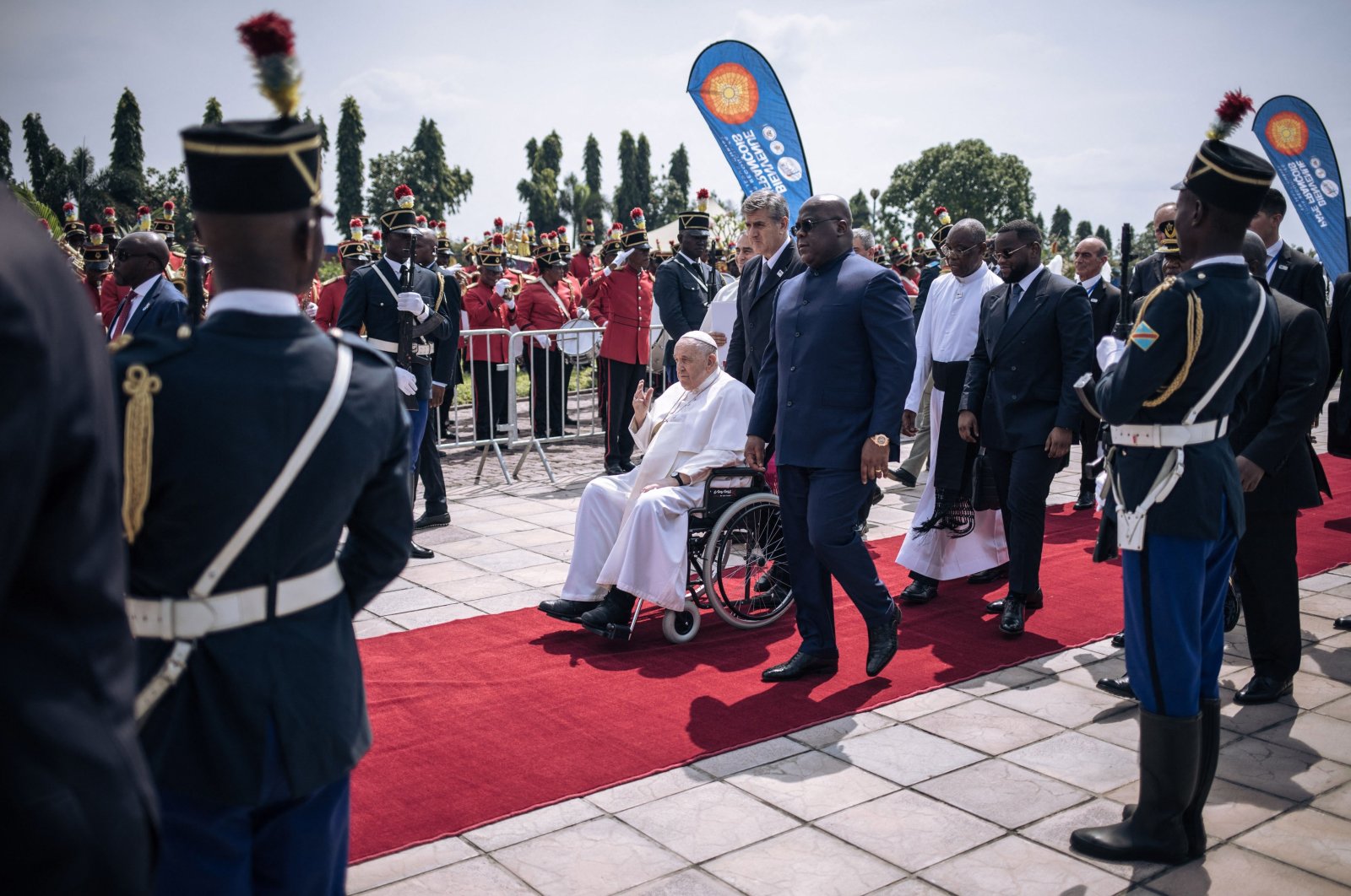 President of the Democratic Republic of the Congo (DRC) Felix Tshisekedi (C-R) walks next to Pope Francis (C-L), seated on a wheelchair, upon the Pope&#039;s departure from the Democratic Republic of Congo (DRC), at the N&#039;djili International Airport, Kinshasa, DRC, Feb. 3, 2023. (AFP Photo)
