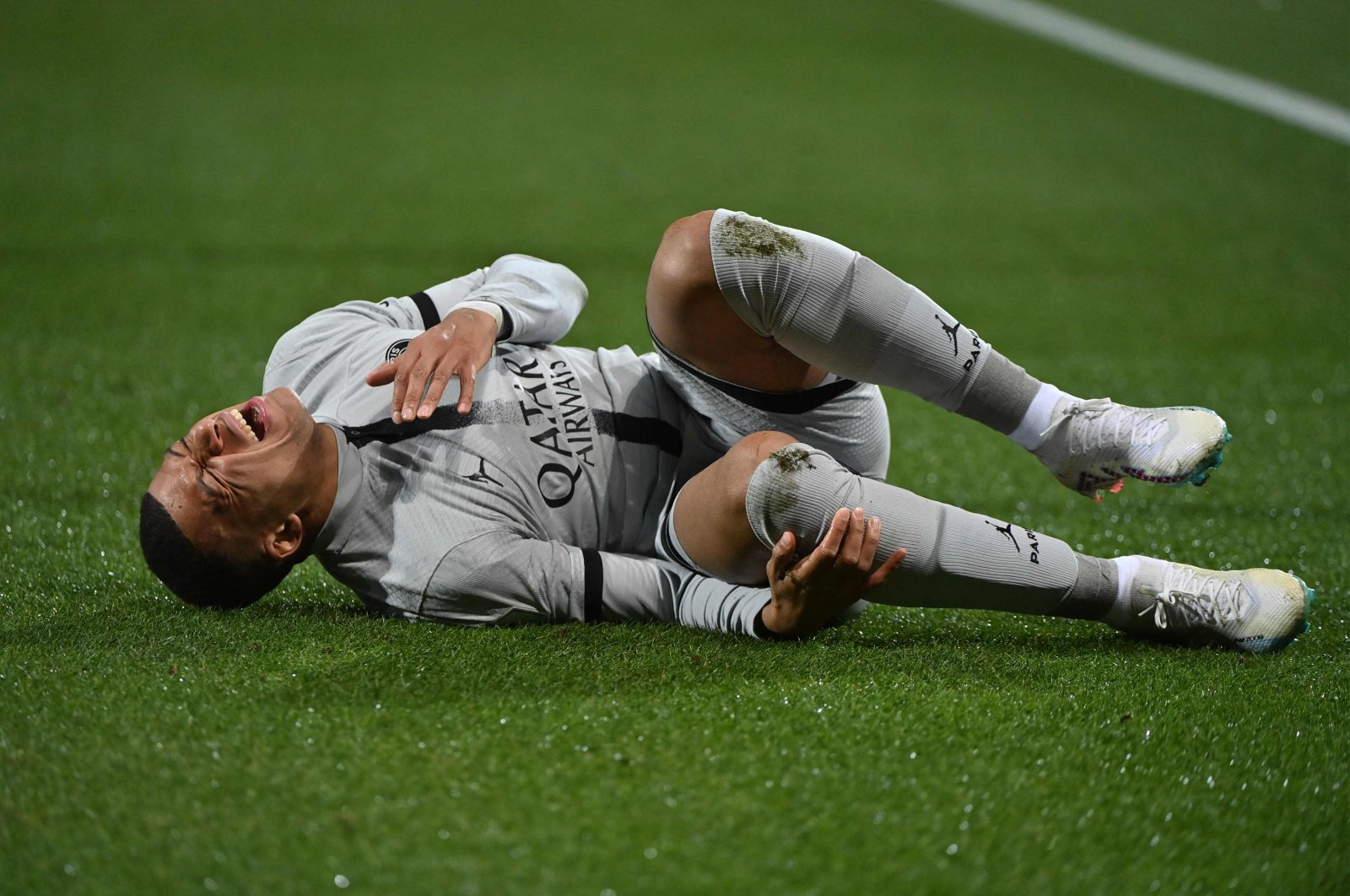 Paris Saint-Germain&#039;s French forward Kylian Mbappe lies on the ground after getting injured during the French L1 football match between Montpellier Herault SC and Paris Saint-Germain (PSG) at Stade de la Mosson in Montpellier, France, Feb. 1, 2023. (AFP Photo)