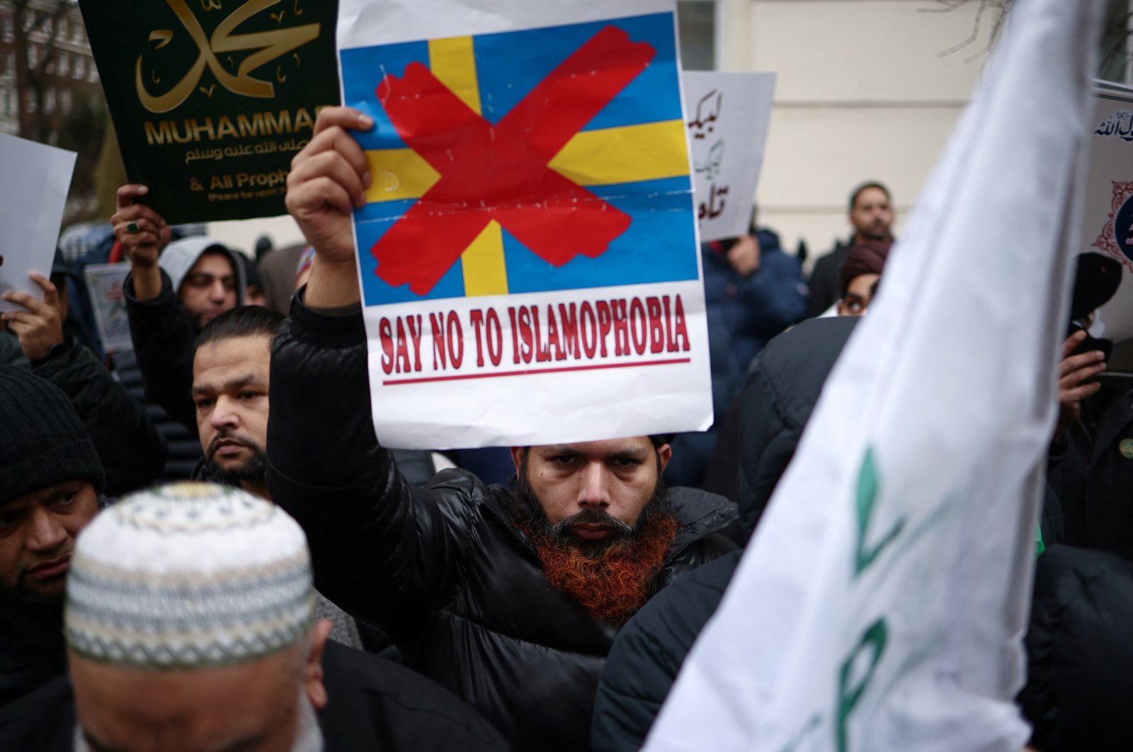 A man displays a placard during a protest following the burning of the Quran in Stockholm, outside the Embassy of Sweden in London, Britain, Jan. 28, 2023. (Reuters Photo)