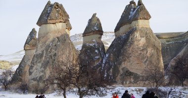 Tourists are seen in front of rock formations in Cappadocia, Nevşehir, Türkiye, Feb. 5, 2023. (DHA Photo)