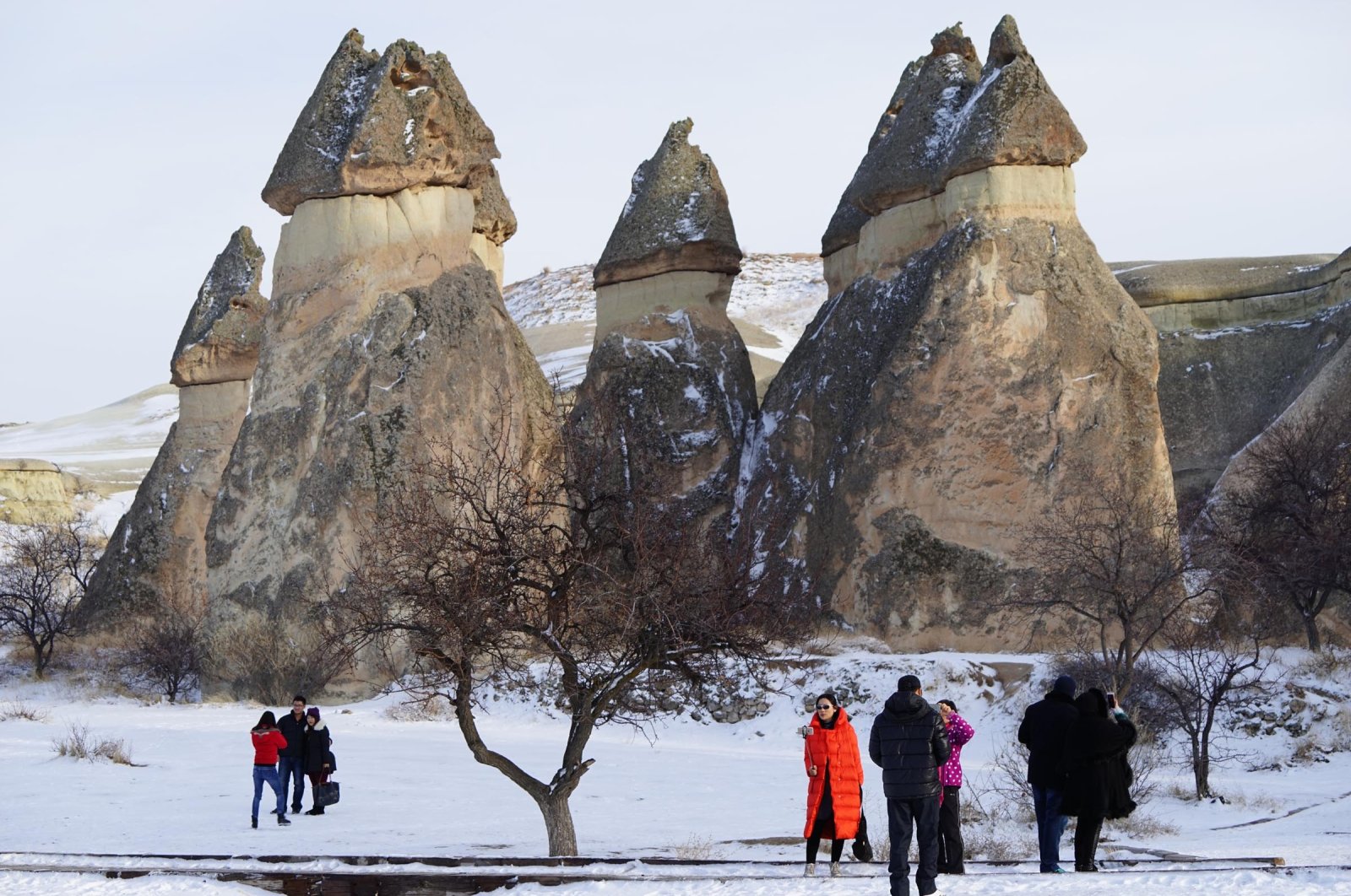 Tourists are seen in front of rock formations in Cappadocia, Nevşehir, Türkiye, Feb. 5, 2023. (DHA Photo)