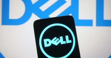 In this photo illustration, the Dell logo is seen on a smartphone and a computer screen in Ukraine, March 15, 2021. (Reuters Photo)