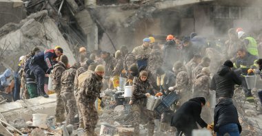 The rescue teams remove bodies from the debris of destroyed buildings in Gaziantep, Türkiye, Feb. 6, 2023. (AA Photo)