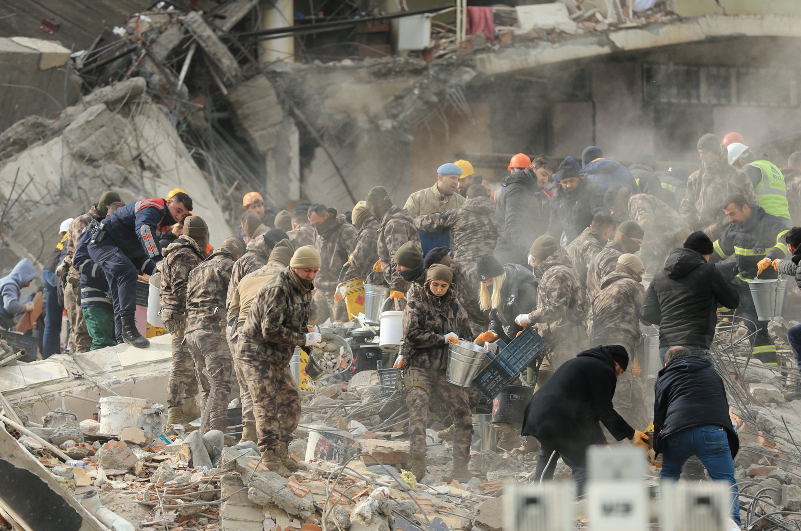 The rescue teams remove bodies from the debris of destroyed buildings in Gaziantep, Türkiye, Feb. 6, 2023. (AA Photo)