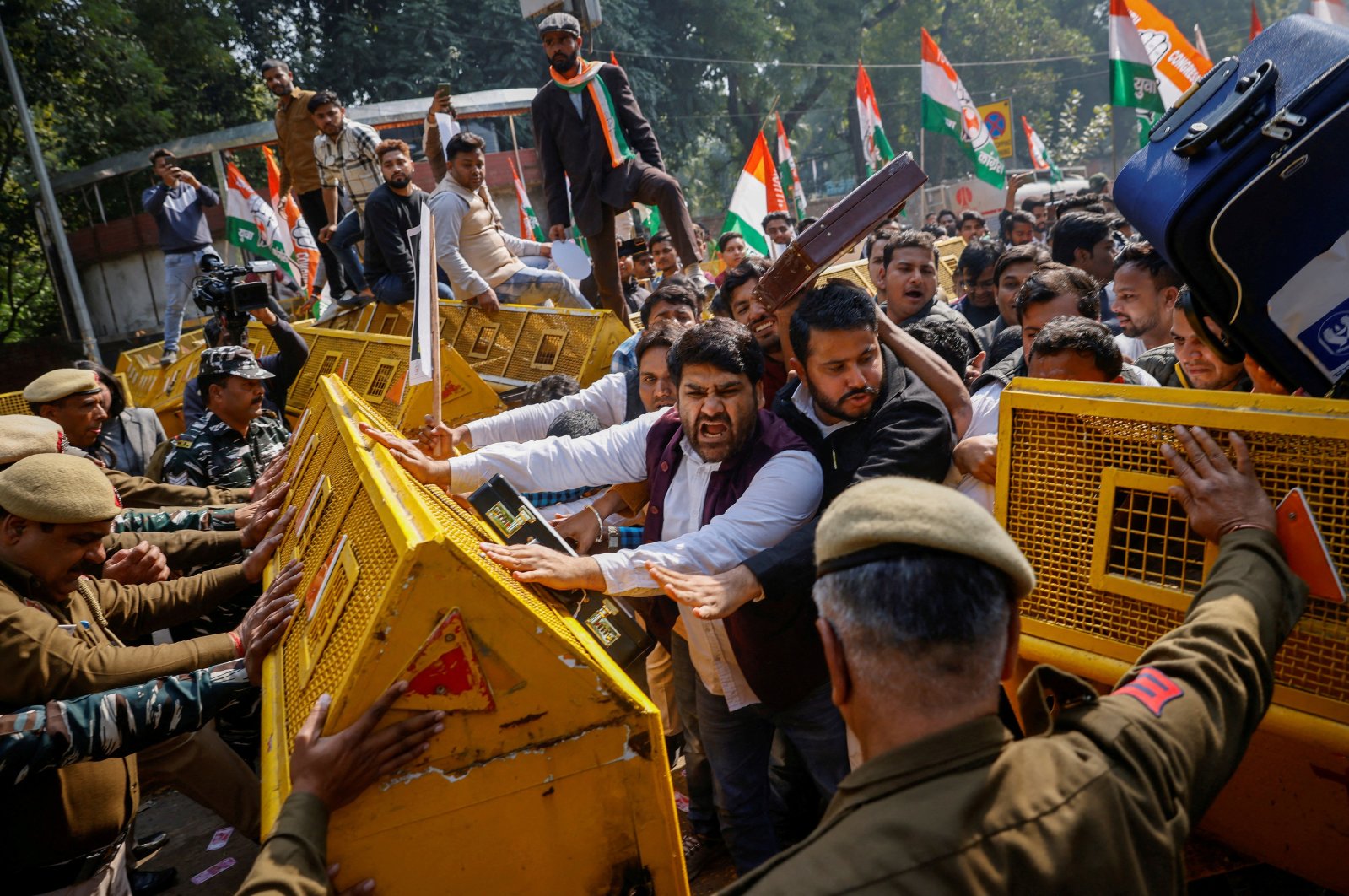 Activists of the youth wing of India&#039;s main opposition Congress party try to break a police barricade during a protest against what they say are investments by Life Insurance Corporation (LIC) and State Bank of India (SBI) in Adani Group, in New Delhi, India, Feb. 6, 2023. (Reuters Photo)