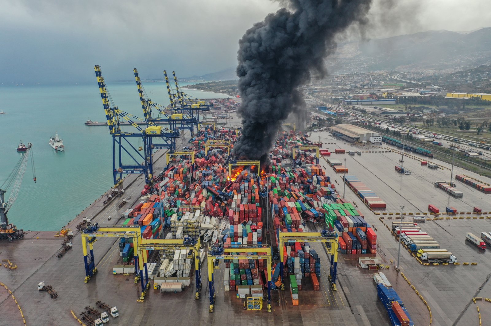Dark smoke rises after a fire broke out among containers toppled at a major port in the Mediterranean coastal city of Iskenderun following an earthquake, southern Türkiye, Jan. 6, 2023. (AA Photo)