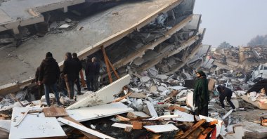 People look at rubble and damage following an earthquake in Hatay, Türkiye, Feb. 7, 2023. (Reuters Photo)