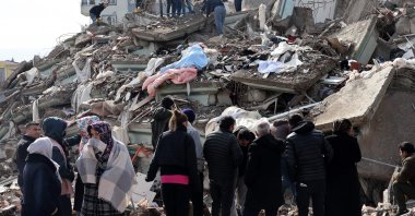 Rescue personnel and families search through the rubble of buildings, after a 7.8-magnitude earthquake struck the country&#039;s southeast, Kahramanmaraş, Türkiye, Feb. 7, 2023. (AFP Photo)