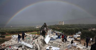 Residents search for victims and survivors amidst the rubble of collapsed buildings following an earthquake in the village of Besnaya in opposition-held Idlib, Syria, Feb. 6, 2022. (AFP Photo)
