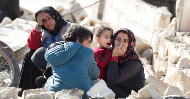 People sitting on the rubble react in the aftermath of an earthquake in oppossition-held Jandaris, Syria, Feb. 6, 2023. (Reuters Photo) 