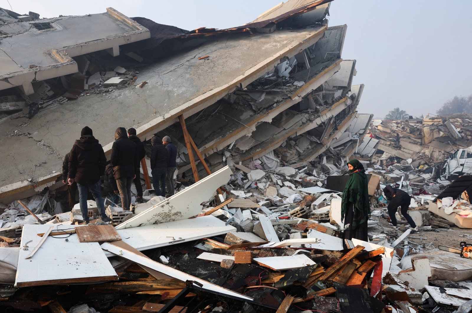 People look at rubble and damage following an earthquake in Hatay, Türkiye, Feb. 7, 2023. (Reuters Photo)