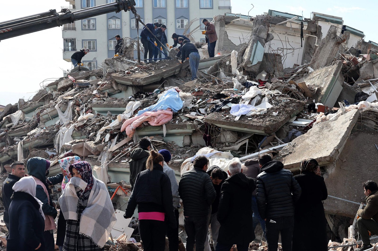 Rescue personnel and families search through the rubble of buildings, after a 7.8-magnitude earthquake struck the country&#039;s southeast, Kahramanmaraş, Türkiye, Feb. 7, 2023. (AFP Photo)