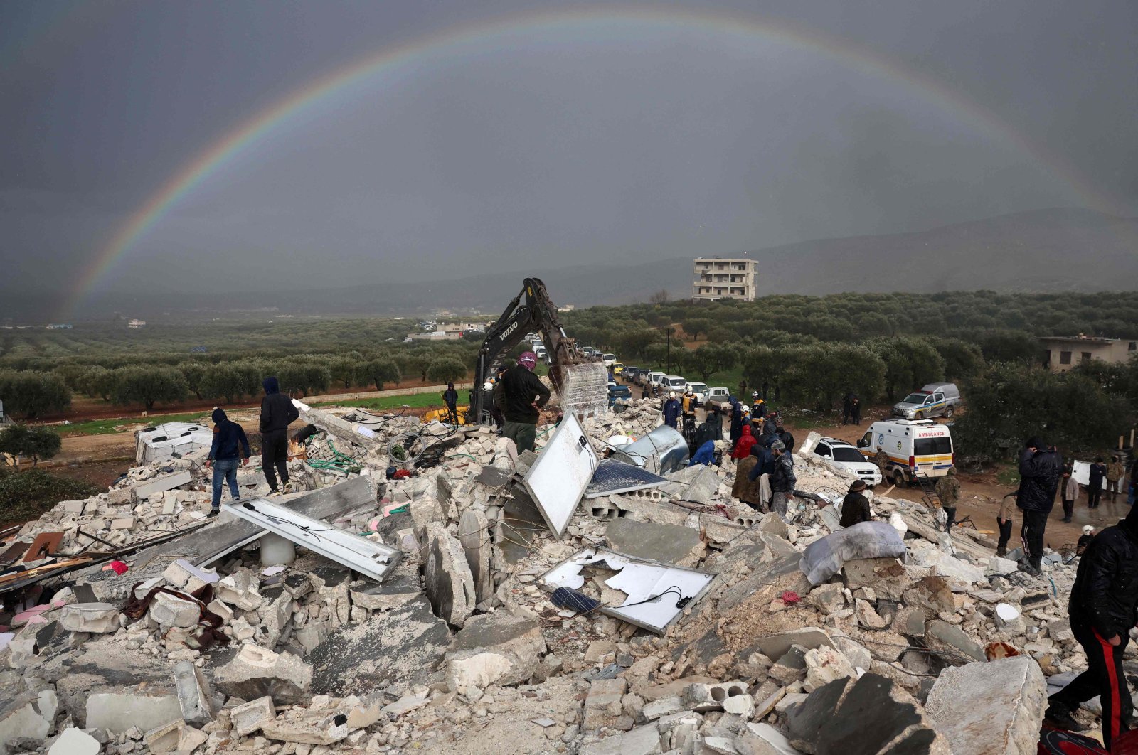 Residents search for victims and survivors amidst the rubble of collapsed buildings following an earthquake in the village of Besnaya in opposition-held Idlib, Syria, Feb. 6, 2022. (AFP Photo)
