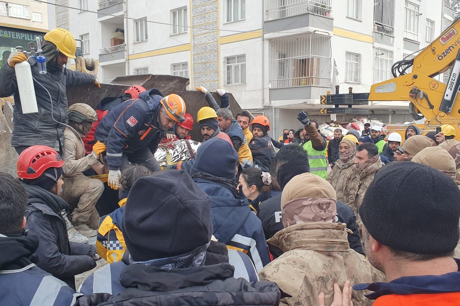 Emergency personnel and locals search for survivors at the site of a collapsed building in the aftermath of a major earthquake, Kahramanmaras, Türkiye, Feb. 8, 2023. (DHA Photo)