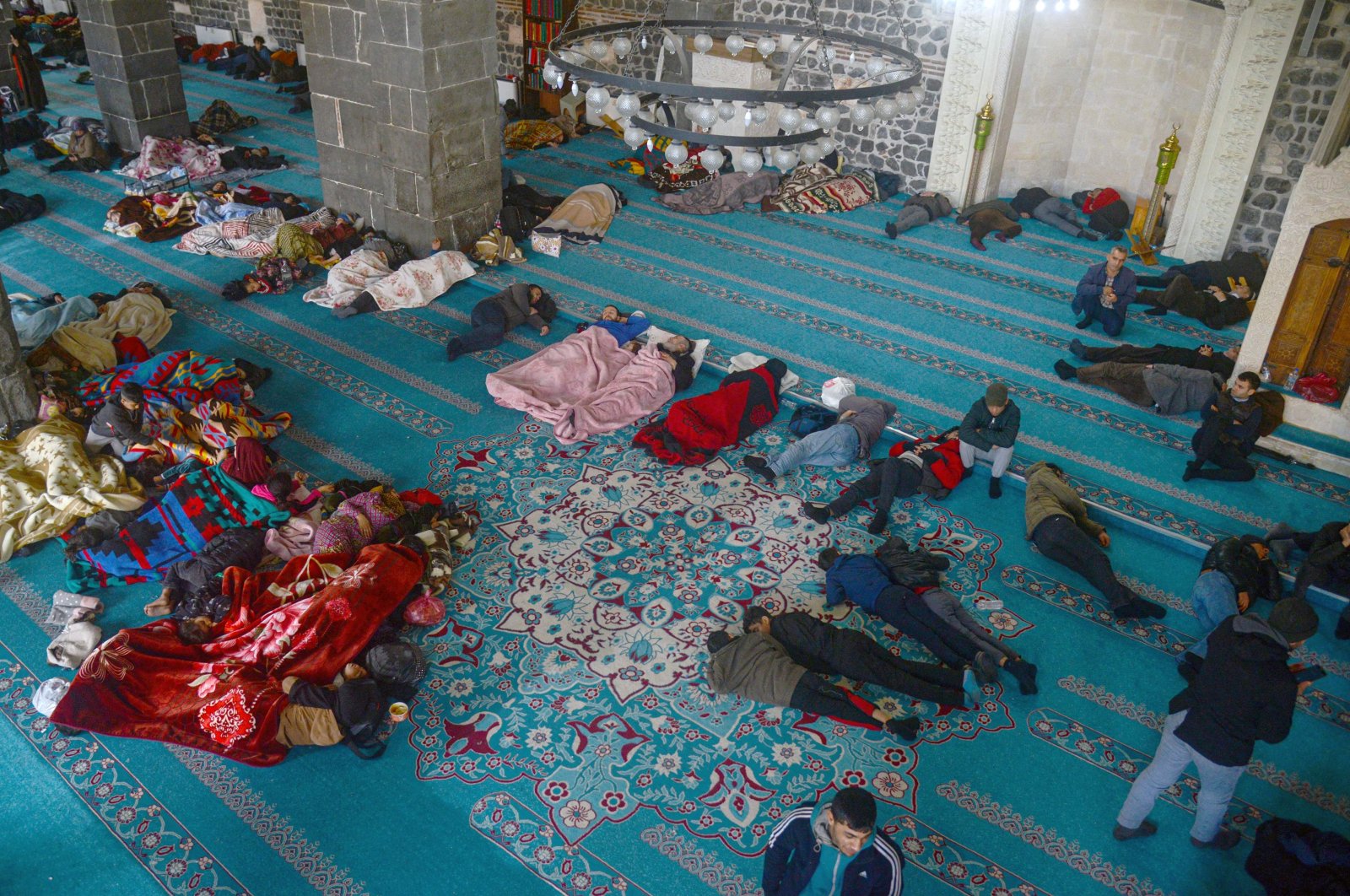 Syrian and Turkish victims of the earthquake rest in the Ulu (Grand) Mosque, in Diyarbakır, southeastern Türkiye, Feb. 8, 2023. (AFP Photo)