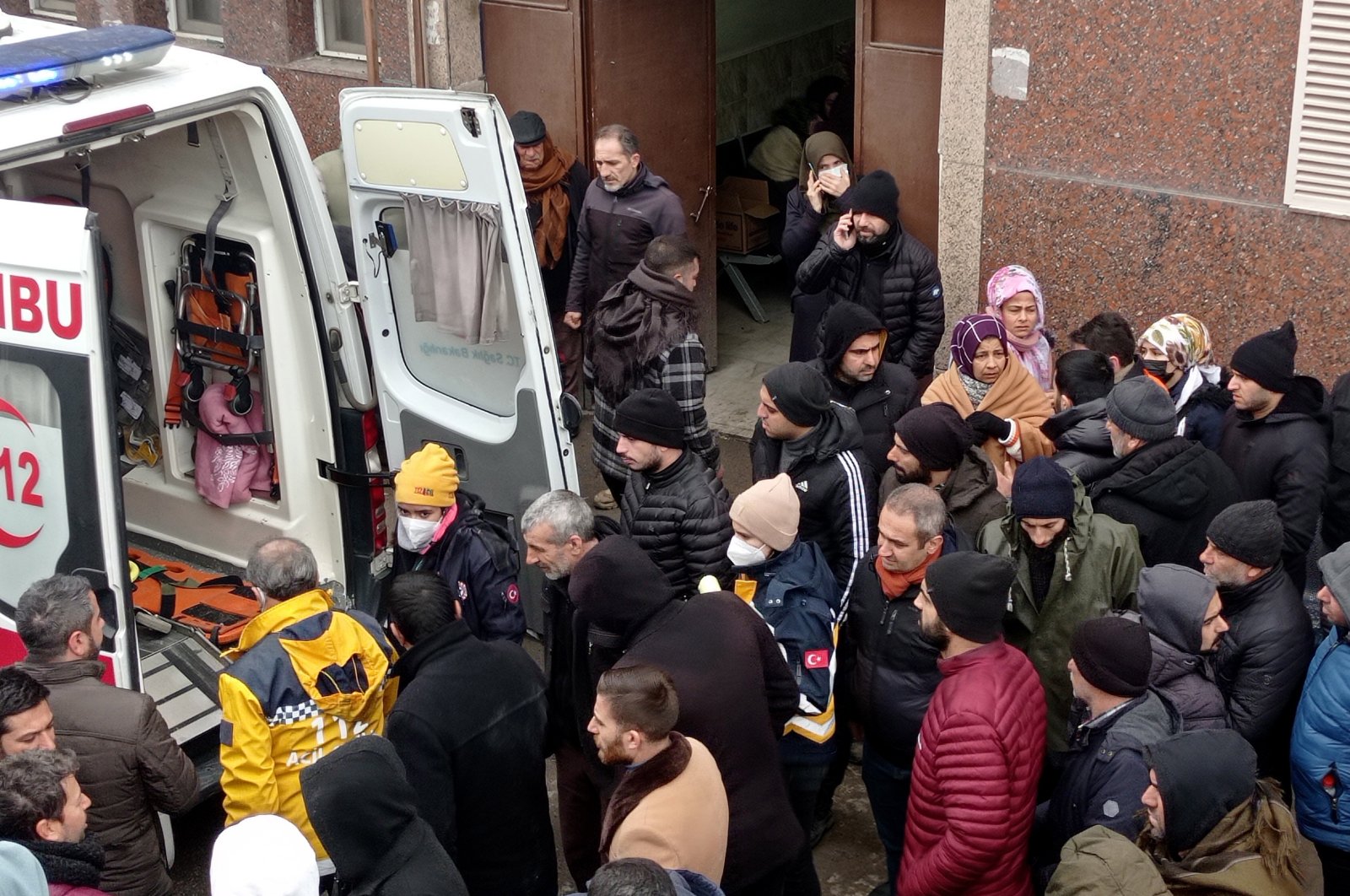 Relatives of victims gather around an ambulance as they wait in front of a morgue section of the state hospital in the aftermath of a major earthquake in Diyarbakir, Türkiye, Feb. 8, 2023. (EPA Photo)