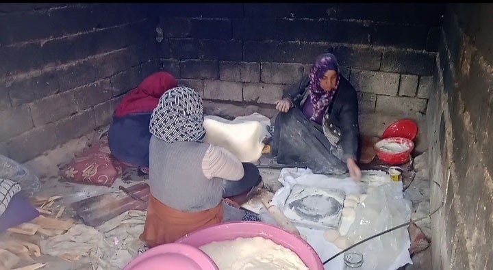 The women from village of Van prepare dough to bake bread for Türkiye's earthquake victims, Van, Türkiye, Feb. 9. 2023. (IHA Photo)