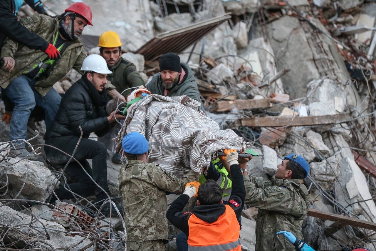 A rescue crew removes 8-year-old Beyan Haddap from the rubble, in Antakya, Hatay, southern Türkiye, Feb. 8, 2023. (AA Photo)