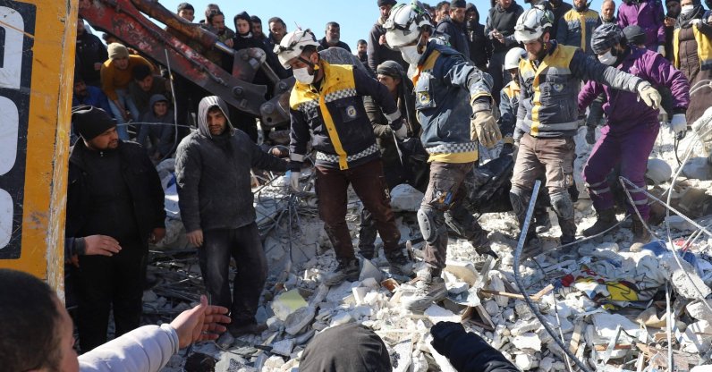 Syrian White Helmet rescuers and residents recover a body from the rubble of a destroyed building in the village of Azmarin, Idlib, northwestern Syria, Feb. 8, 2023. (AFP Photo)