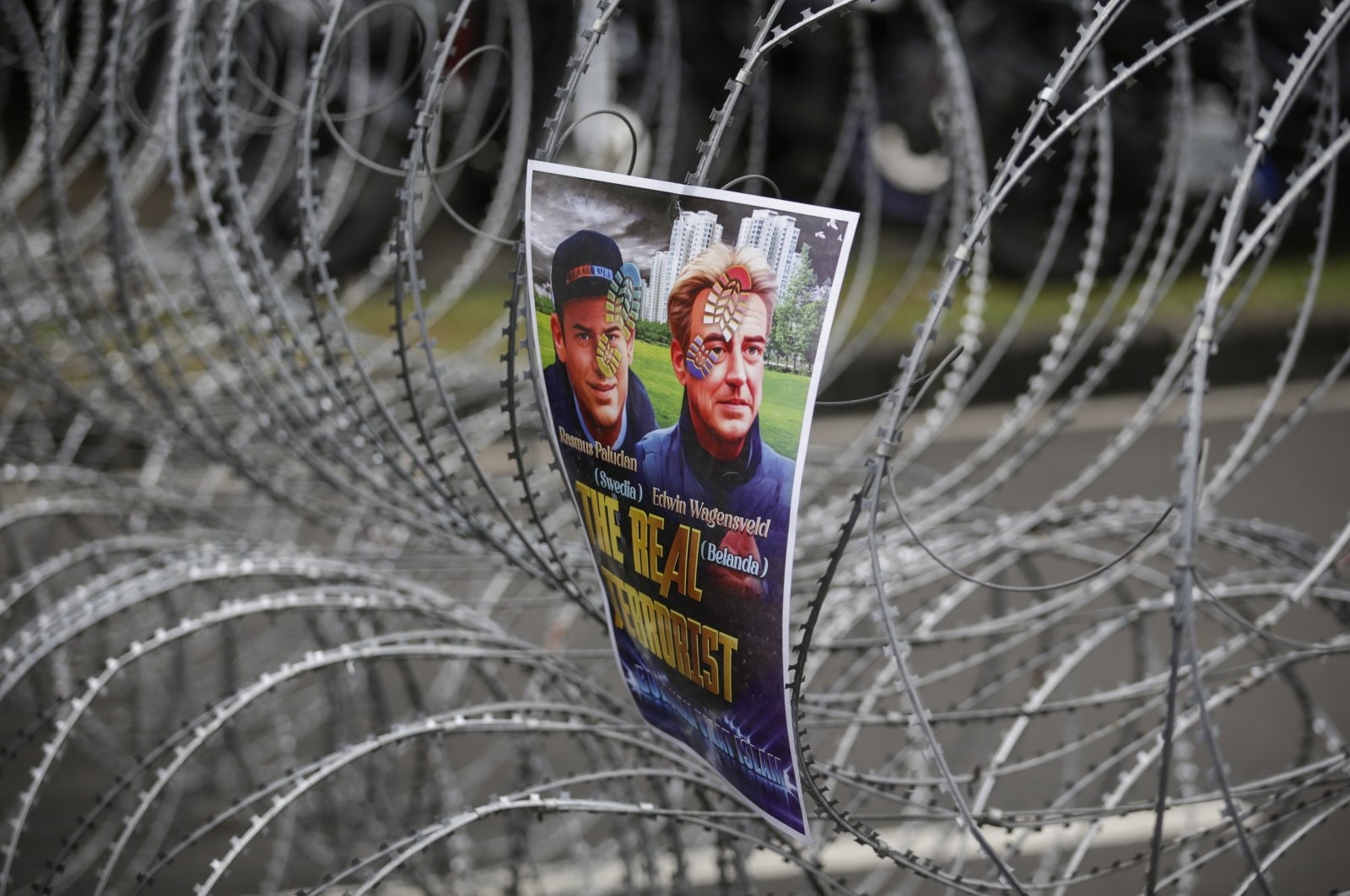 A poster with pictures of Rasmus Paludan and Edwin Wagensveld hang on barbed wire during an anti-Sweden rally outside the Swedish Embassy in Jakarta, Indonesia, Jan. 30, 2023. (EPA Photo)