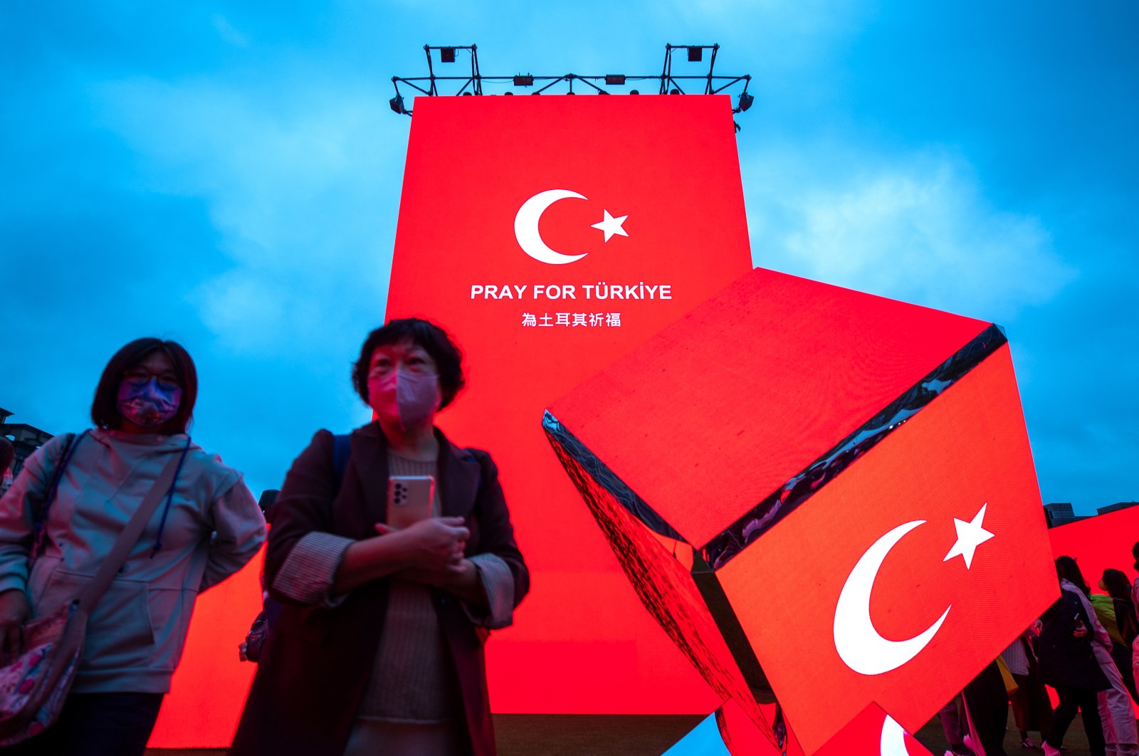 People walk past a LED screen displaying a "Pray for Türkiye" message in Taipei, Taiwan, Feb. 8, 2023. (EPA Photo)