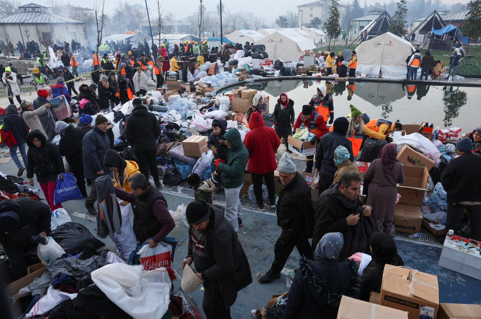 People look through boxes of aid materials in the aftermath of a deadly earthquake in Hatay, Türkiye, Feb. 9, 2023. (Reuters Photo)