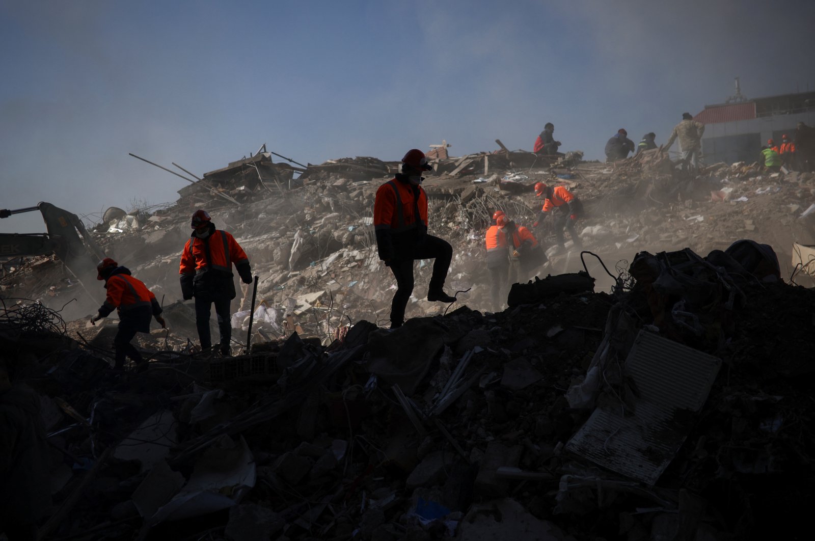 Rescuers walk over the rubble in the aftermath of a deadly earthquake in Kahramanmaraş, Türkiye, Feb. 9, 2023. (Reuters Photo)