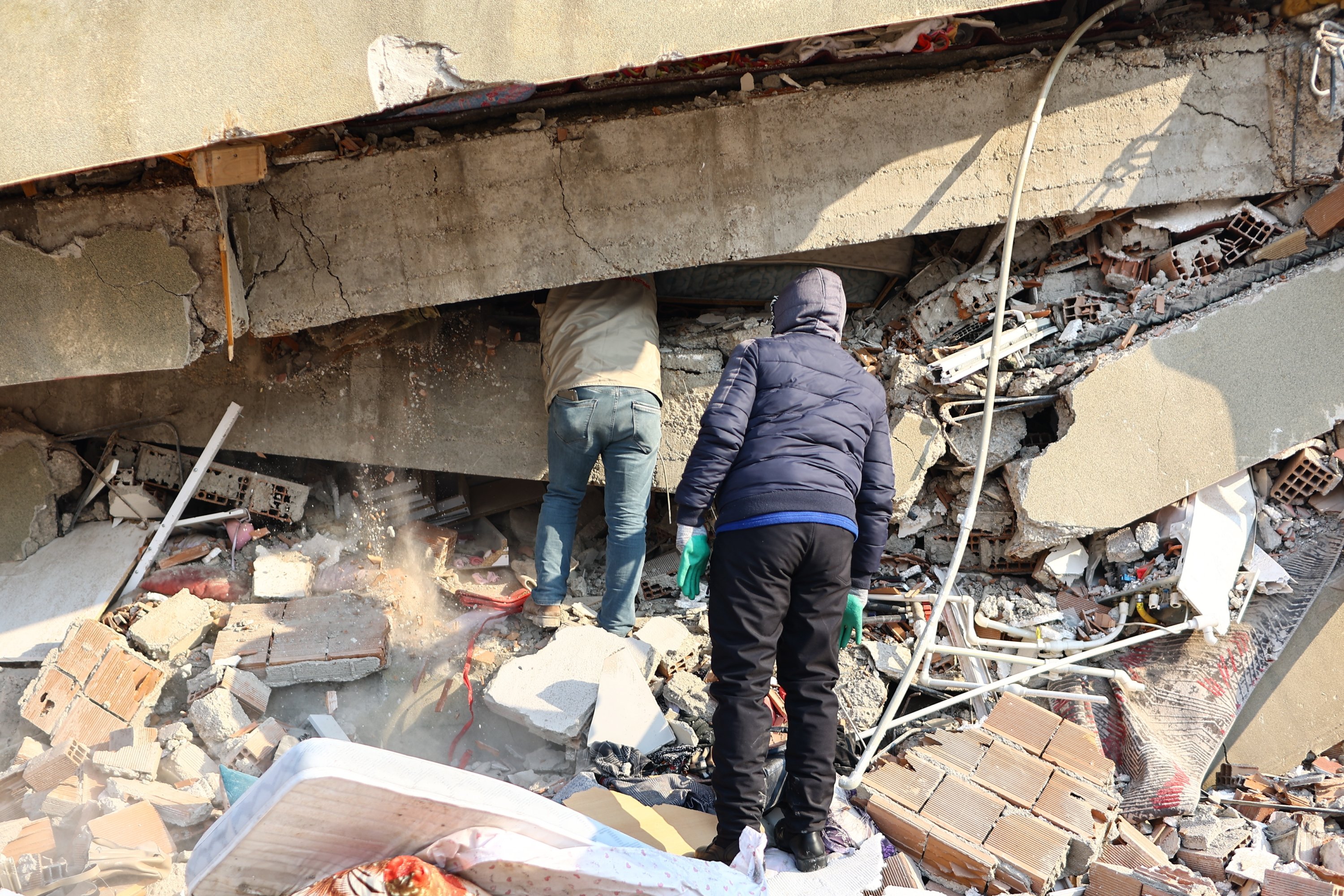 Locals work at the site of collapsed buildings following a powerful earthquake in the Elbistan district, Kahramanmaraş, Türkiye, Feb. 10, 2023. (EPA Photo)