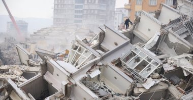 A man walks amid the debris of a collapsed building, in the aftermath of a deadly earthquake in Kahramanmaraş, Türkiye, Feb. 10, 2023. (Reuters Photo)