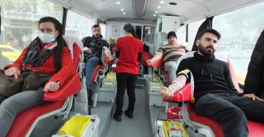 Citizens donate blood in the Turkish Red Crescent's bus in Burhaniye, Balikesir, western Türkiye, Feb. 9, 2023. (IHA Photo)