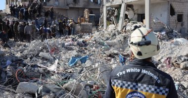 Rescue workers look for survivors amid the rubble of a building in the opposition-held town of Jindayris, northwestern Syria, Feb. 9, 2023. (AFP Photo)
