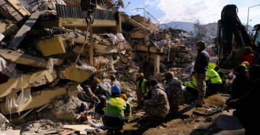 Rescuers stay silent as they try to hear a response from a potential survivor, in the aftermath of the deadly earthquake in Hatay, Türkiye, Feb. 10, 2023. (Reuters Photo)