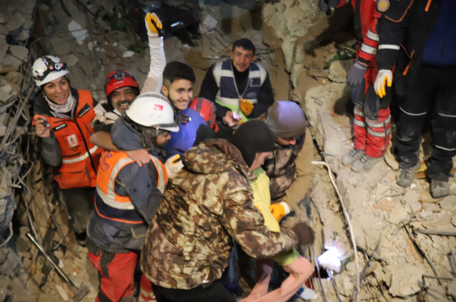 Rescue crews assist a smiling Adnan Korkut as he is pulled from the rubble, in Gaziantep, southern Türkiye, Feb. 10, 2023. (İHA Photo)