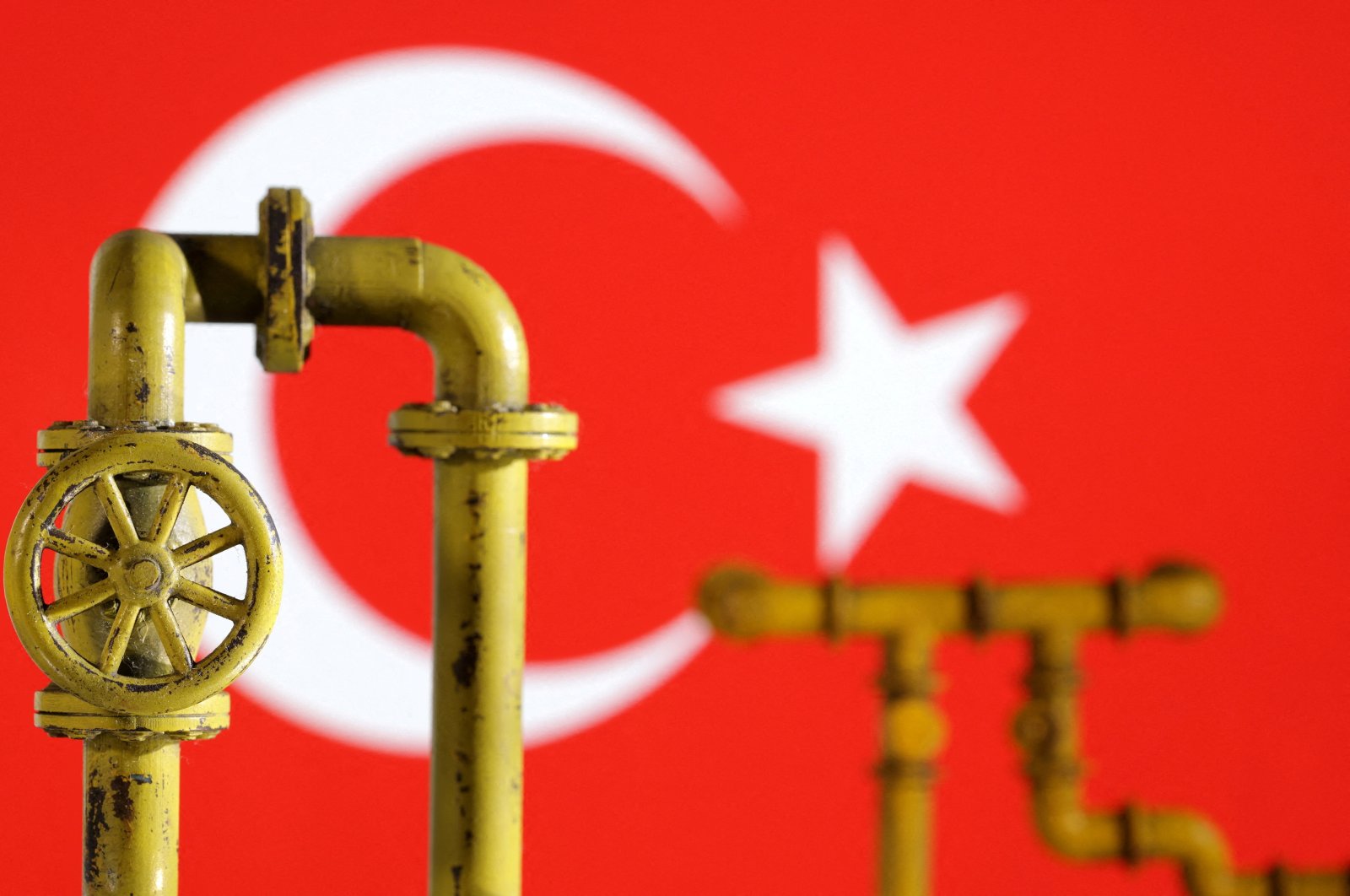 This illustration shows a model of a natural gas pipeline and the Turkish flag, July 18, 2022. (Reuters Photo)