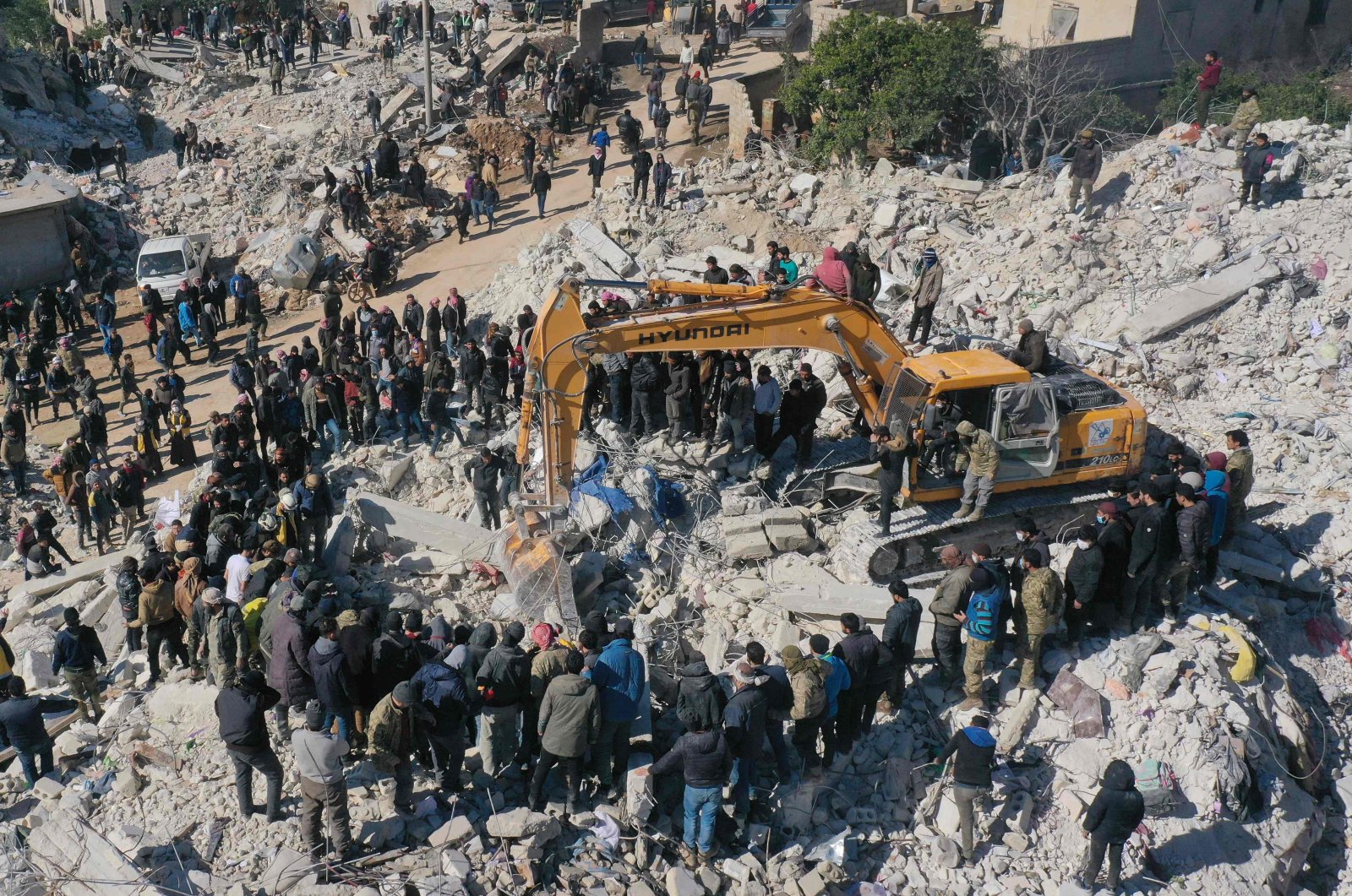 This aerial view shows rescuers searching for survivors amid the rubble of a collapsed building in the town of Harim in Syria&#039;s opposition-held northwestern Idlib province on the border with Türkiye, Feb. 8, 2023. (AFP Photo)