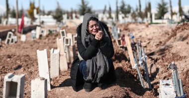 A woman mourns her relatives at a mass grave area following a major earthquake in Adıyaman, southeastern Türkiye, Feb. 11, 2023. (EPA Photo)