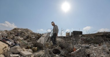 A Syrian boy, who lost his family and was also wounded in the deadly earthquake, walks amid the rubble of his family home, Jindayris, in the opposition-held part of Aleppo, Syria, Feb. 11, 2023. (AFP Photo)