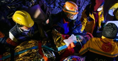 Teams carry Sibel Kaya, who was rescued from the rubble in Gaziantep, southern Türkiye, Feb. 13, 2023. (AA Photo)