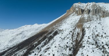 Smoke and ash coat the side of Kuşkayası mountain in Göksun after the earthquake, Kahramanmaraş, Türkiye, Feb. 11, 2023. (AA Photo)