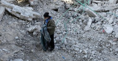 Syrian father Nader Fadil, who lost his wife and two children in the earthquake, stands on the rubble of his damaged home, Jableh, Syria, Feb. 12, 2023. (Reuters Photo)