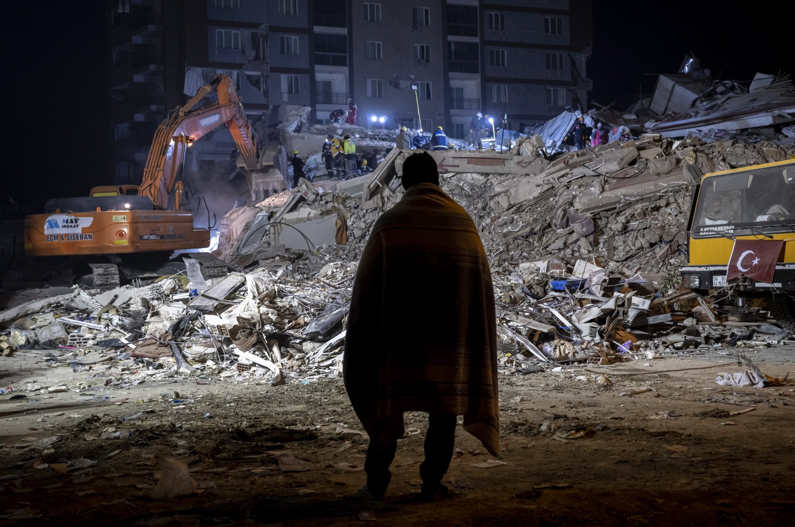 A survivor watches the ongoing rescue work in the debris after the earthquake, Hatay, Türkiye, Feb. 13, 2023. (AA Photo)