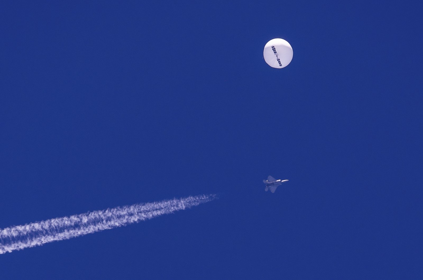 A U.S. F-22 fighter jet flies near a suspected Chinese spy balloon above the Atlantic Ocean, off the coast of South Carolina, U.S., Feb. 4, 2023. (AP Photo)