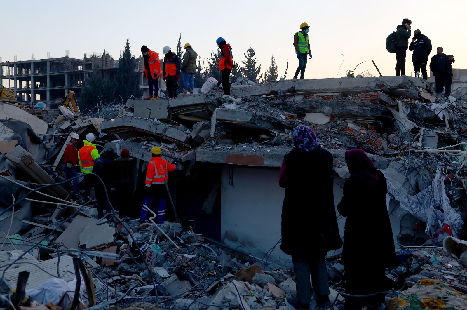 Emergency personnel and local people work at the site of collapsed buildings following a powerful earthquake in Adıyaman, southeastern Türkiye, Feb. 12, 2023. (EPA Photo)