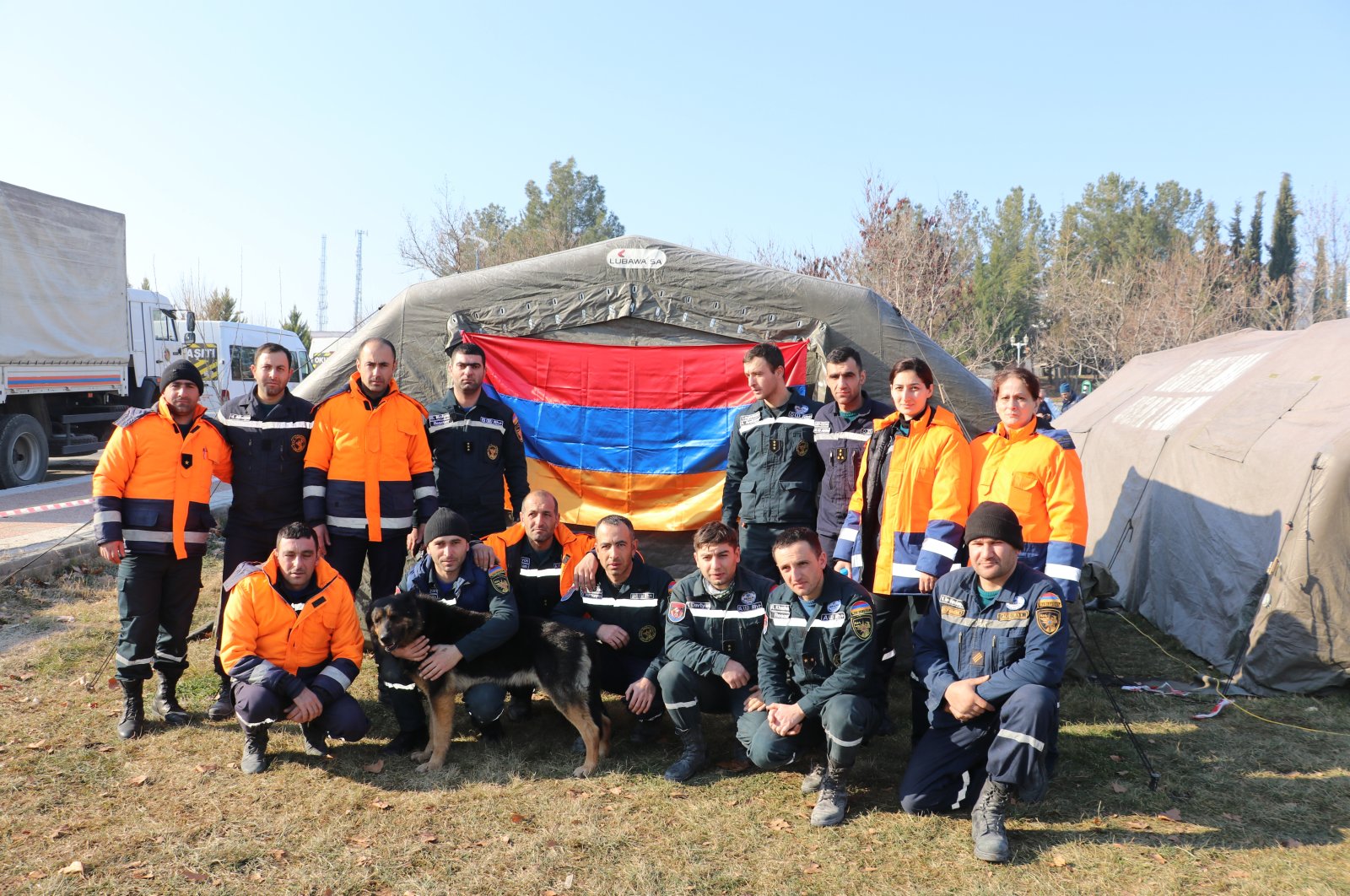 Members of an Armenian search and rescue team pose for a picture with the Armenian flag in Türkiye&#039;s Adıyaman province amid efforts to pull survivors from the rubble following two deadly earthquakes in the country&#039;s southeastern regions, Feb. 12, 2023. (AA Photo) 