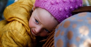 One-and-a-half year old Amar, a Syrian refugee living in Türkiye, looks on as the search for survivors continues in the aftermath of a deadly earthquake in Kahramanmaraş, Türkiye, Feb. 13, 2023. (Reuters Photo)